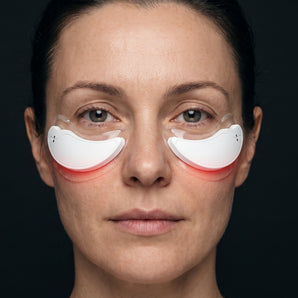 A woman wearing the two white Eyetech 2.0 pods under her eyes